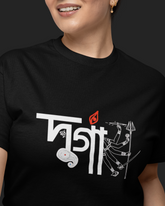 Person wearing a black t-shirt with white and red graphic design on a dark background